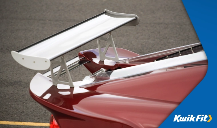 Modified car with large aftermarket spoiler � potentially affecting the resale value of the car.