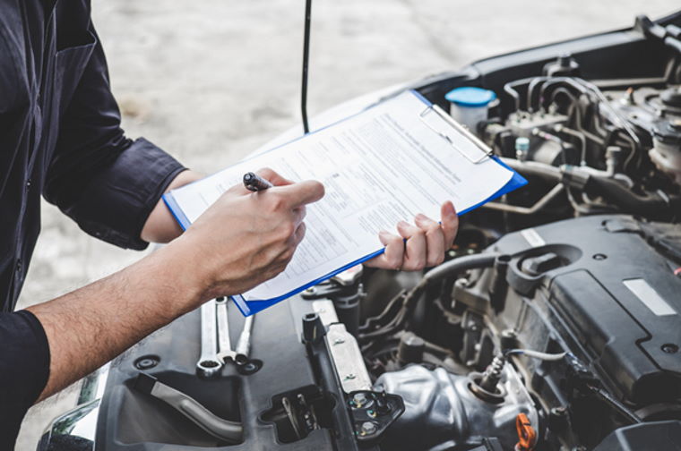 Technician making notes on a clipboard